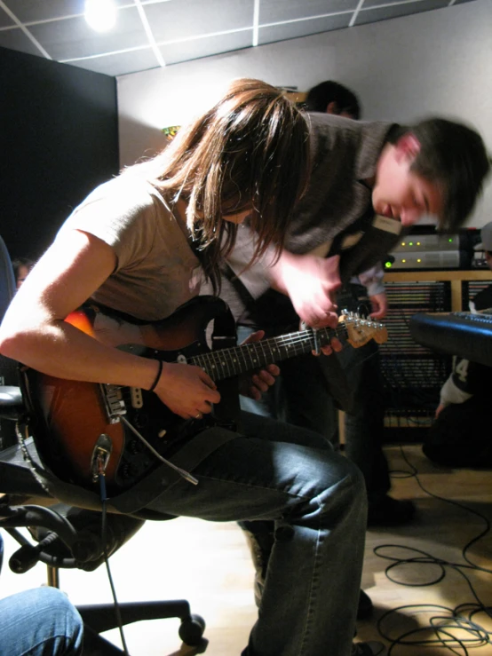 two people playing the guitar with each other