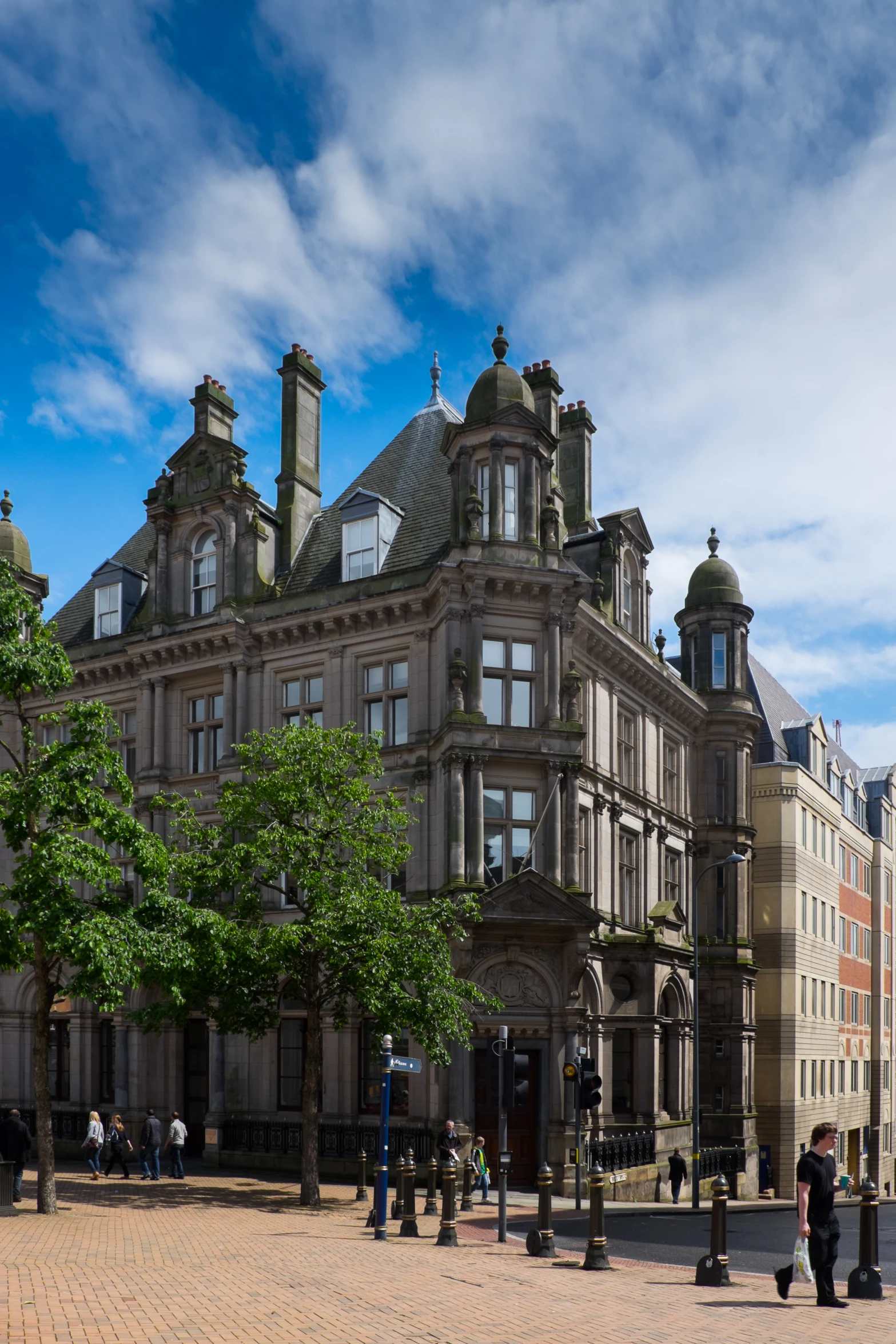 a large building sitting under a cloudy blue sky