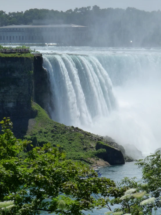 waterfall seen on the side of a large body of water