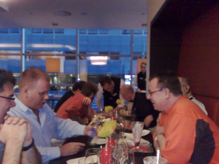 a group of people sitting at a table eating