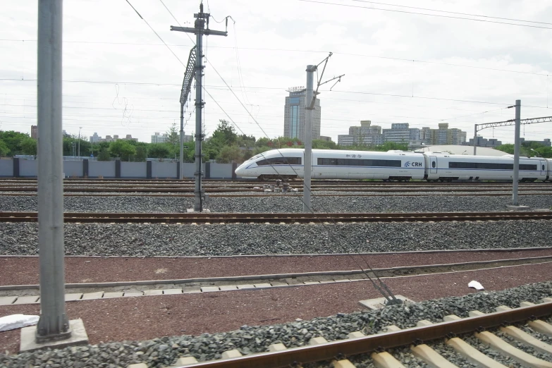 a high speed train riding along the railroad tracks