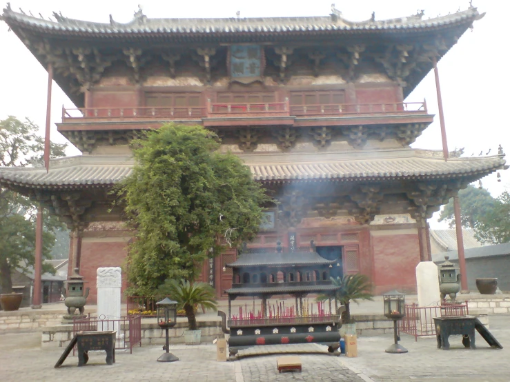 the large chinese building has plants growing out of it