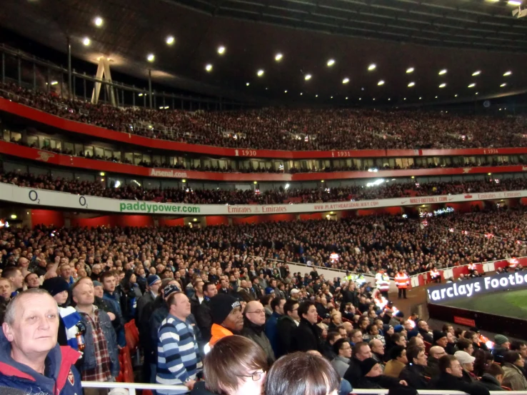 a large crowd is watching a soccer game