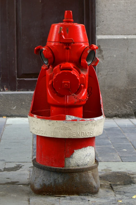 a red fire hydrant is on the sidewalk