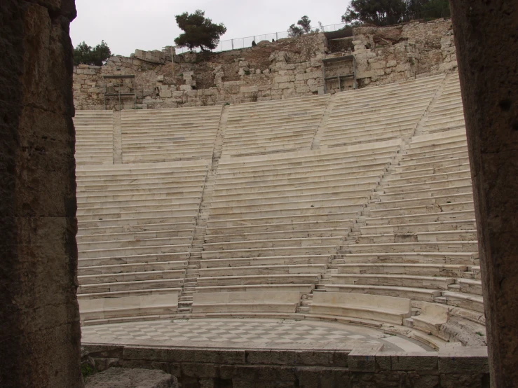 a large theater with stone walls and steps