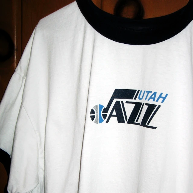 a white shirt with blue and black text that says utah jazz