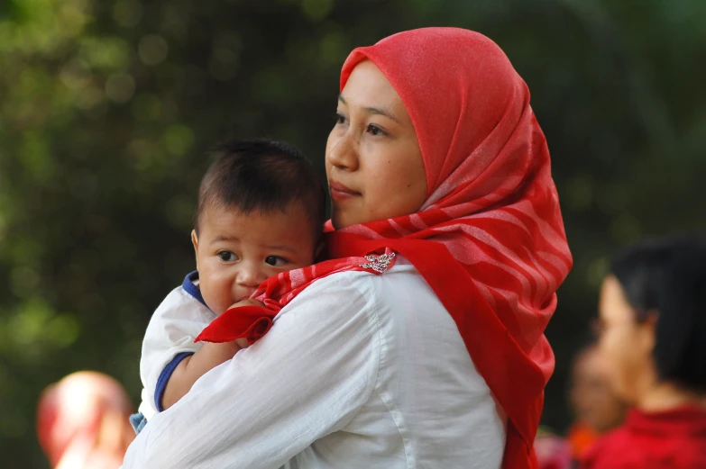 the woman is holding the child in her arms