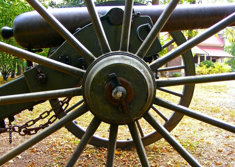 large metal cannon with three large guns on the front