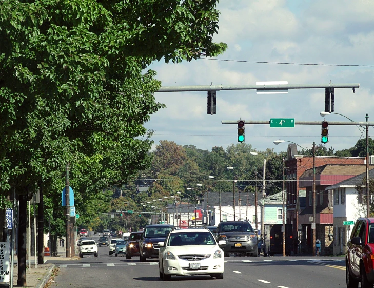 a street intersection with cars waiting for the green light