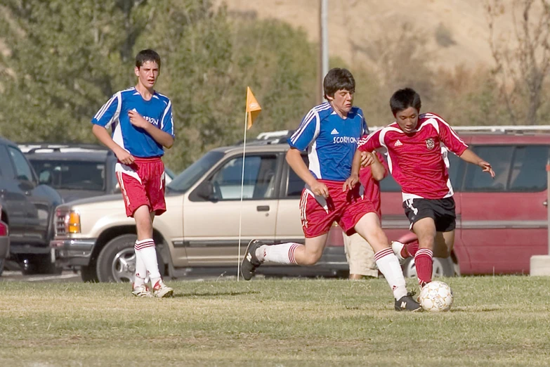 the two teams play a game on the soccer field