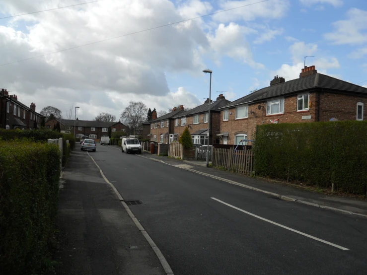 a street that has houses and cars on it