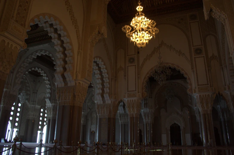 a fancy chandelier hangs in a dimly lit building