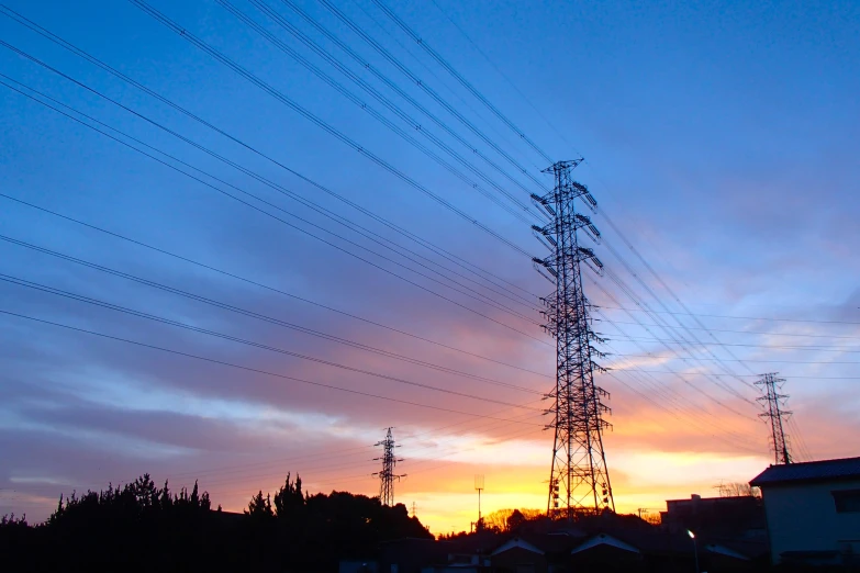 a telephone pole with a sky background that appears to be dark