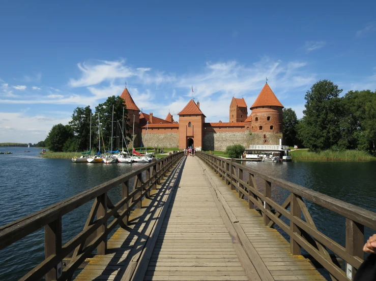 a bridge crosses over the water with a castle in the background