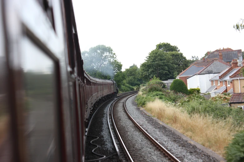 a train traveling down tracks through a rural area