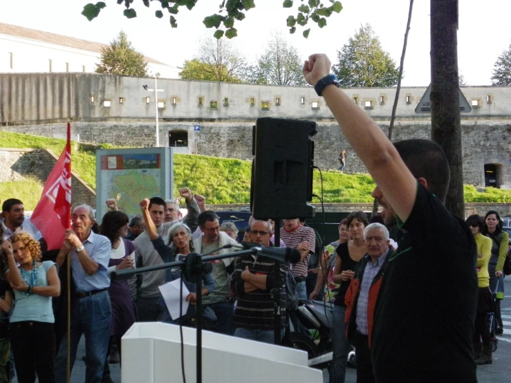 a man standing in front of a microphone holding a cellphone