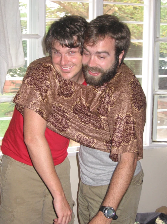 two men holding each other with a smile on their faces