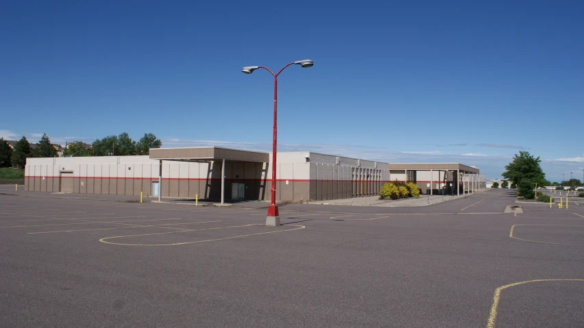 the outside of a storage facility with several cars in it