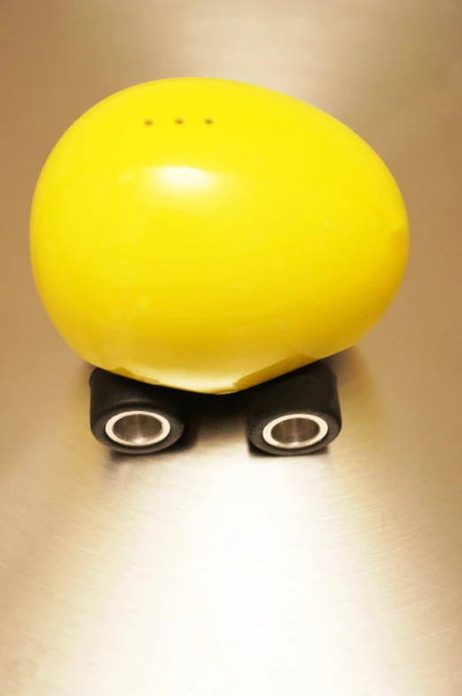 a yellow item with black plastic handles on a metal surface