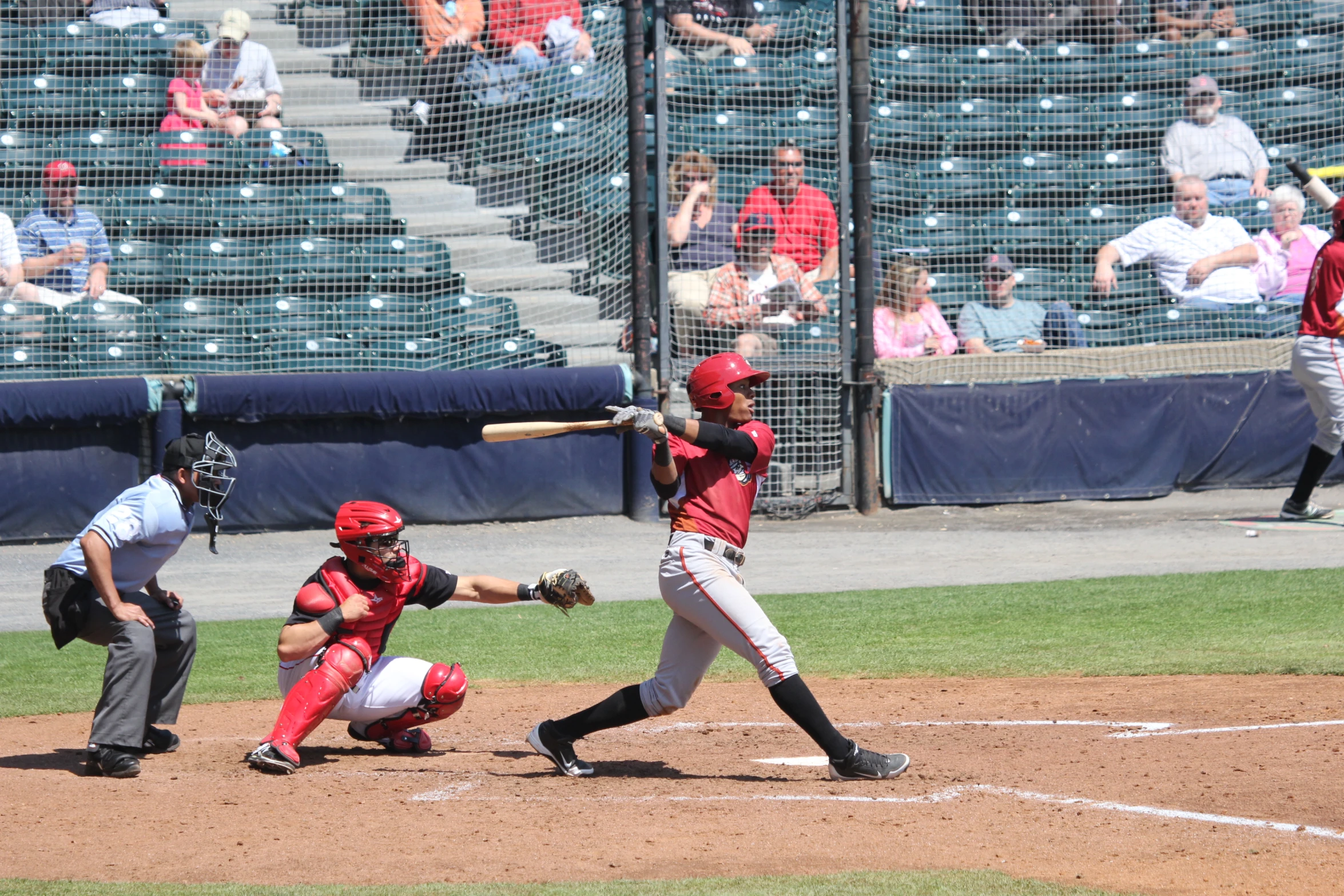 the baseball player swings at the ball during a game