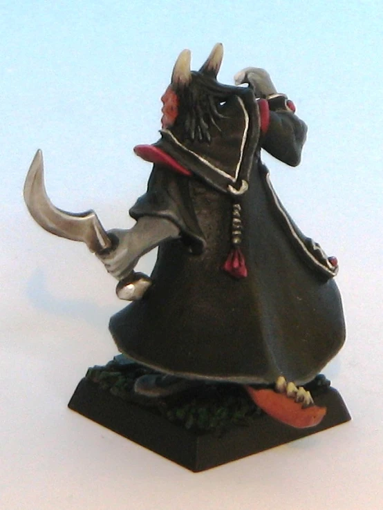 a miniature statue is wearing a devil costume