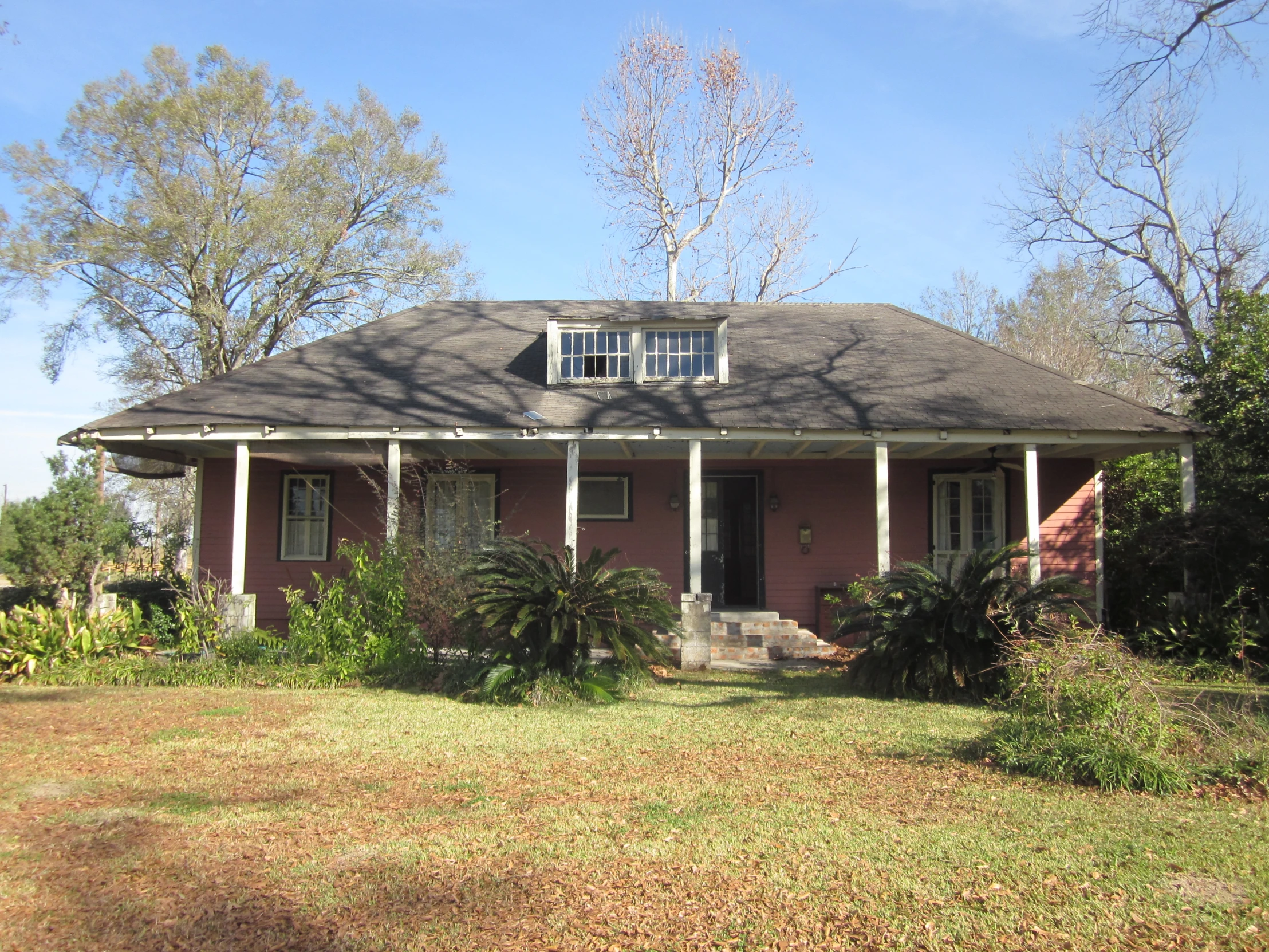 a home with a red brick front yard