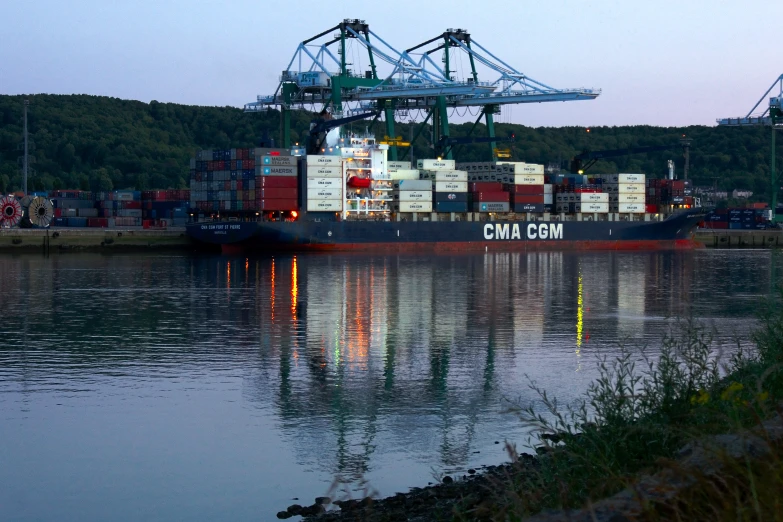 large cargo ship moored at port with crane behind