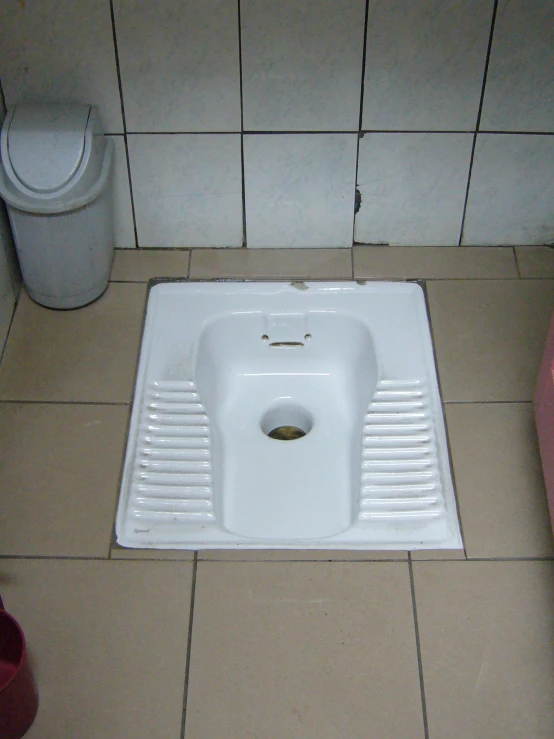 a small square white sink in a bathroom