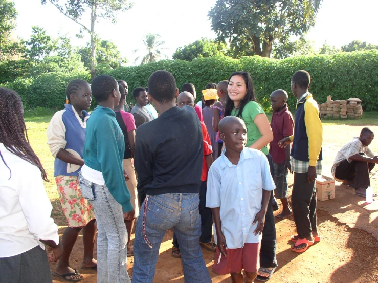 a group of people stand in front of a man with an ear piece