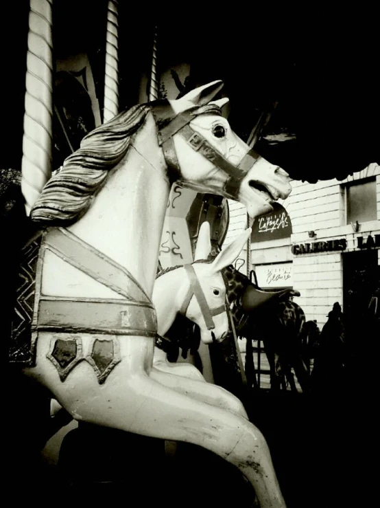 a carousel horse on the front of a small building