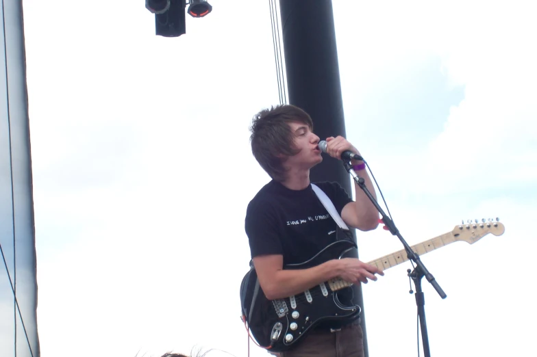 a man singing into a microphone at a music festival