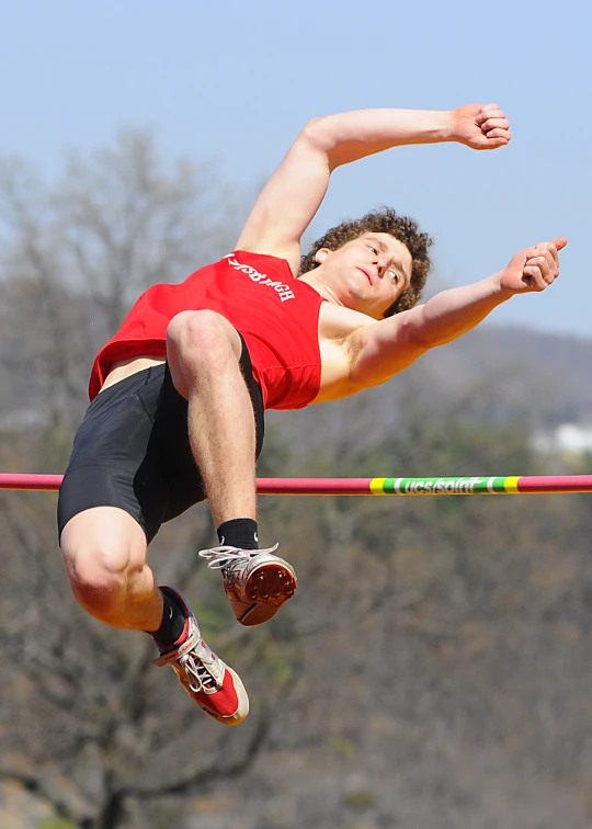 a man is jumping a high jump in the air