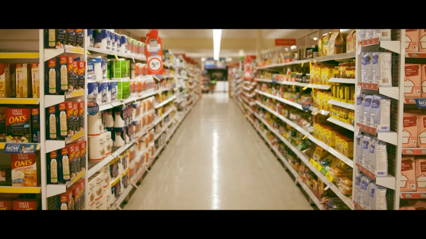 several shelves are filled with beverages in a grocery store