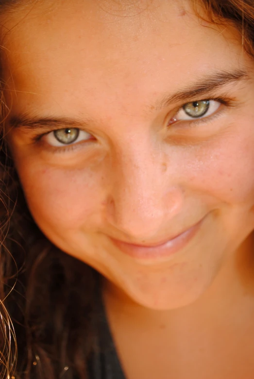 a close up of a girl looking at the camera