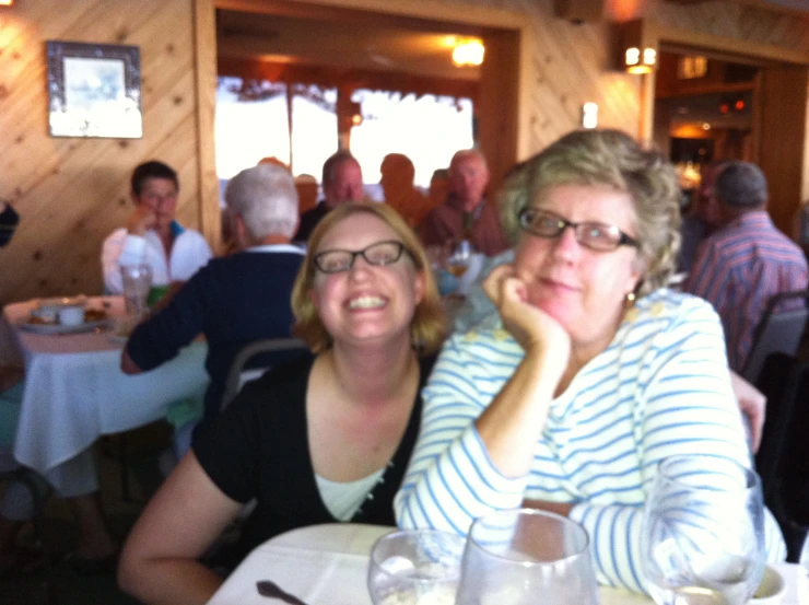 two women sitting at a table in a restaurant