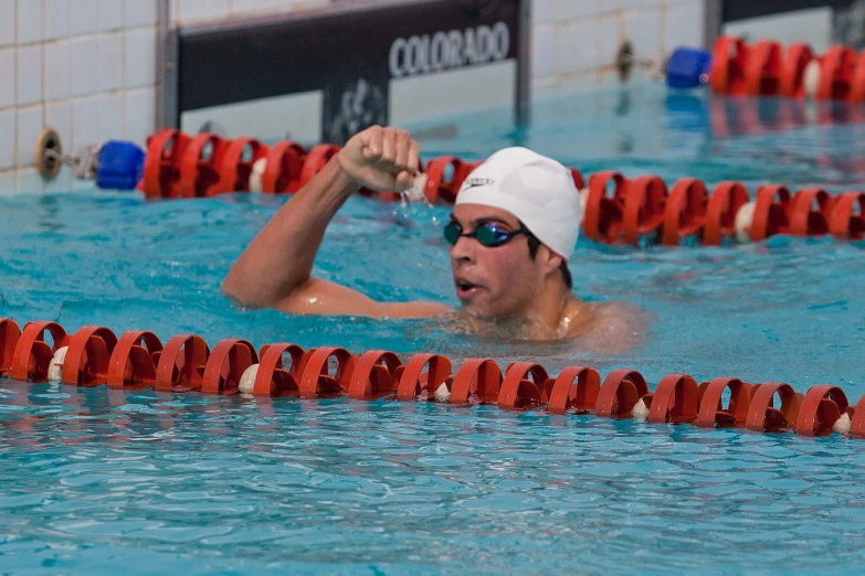 a male swimmer in the pool ready for his swim