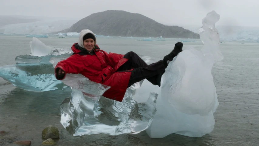 a person laying on some ice in the water