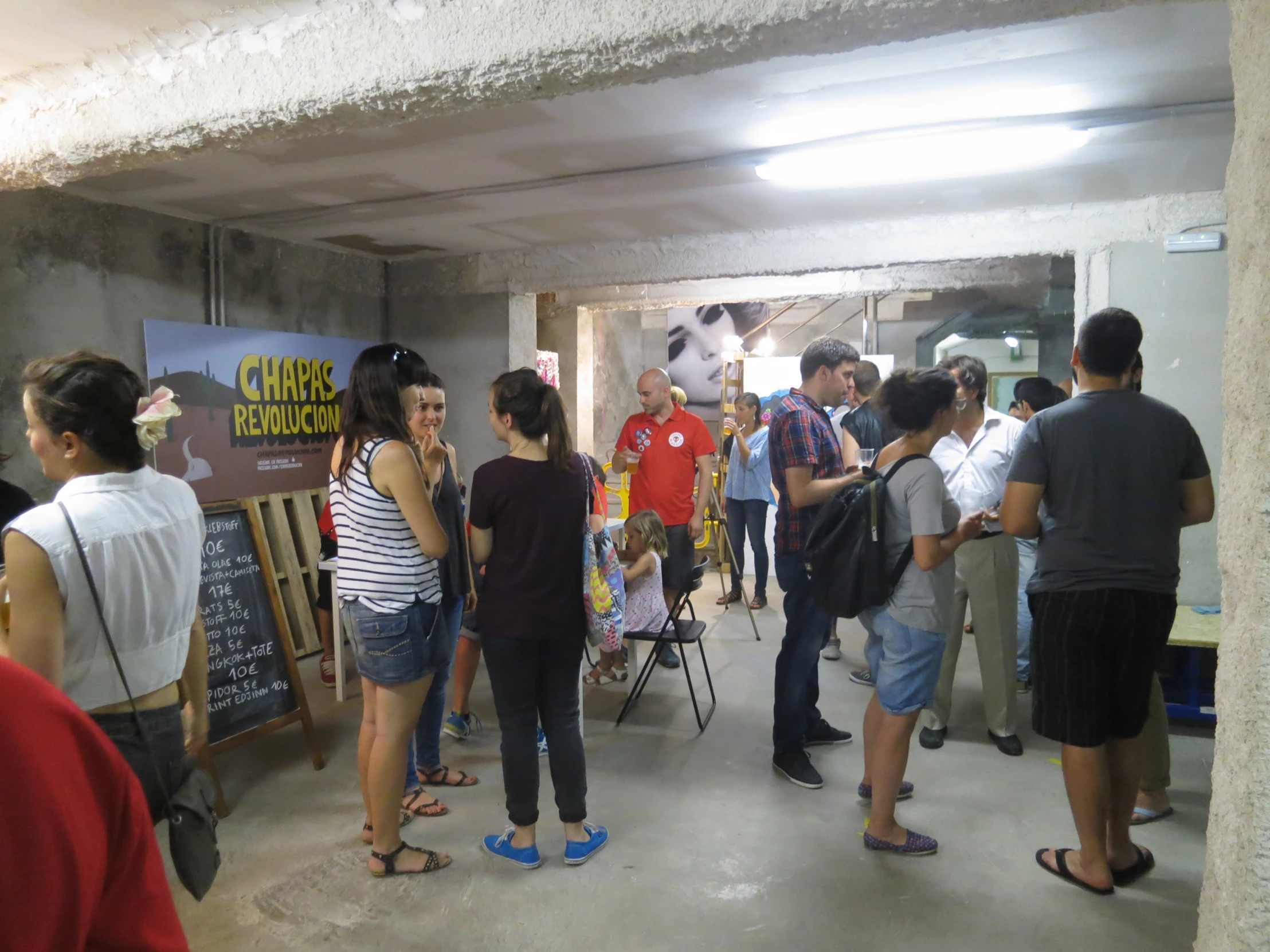 several people talking to each other in an unfinished building