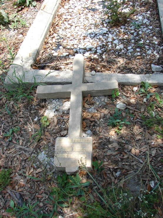 the grave is sitting in a dirt field