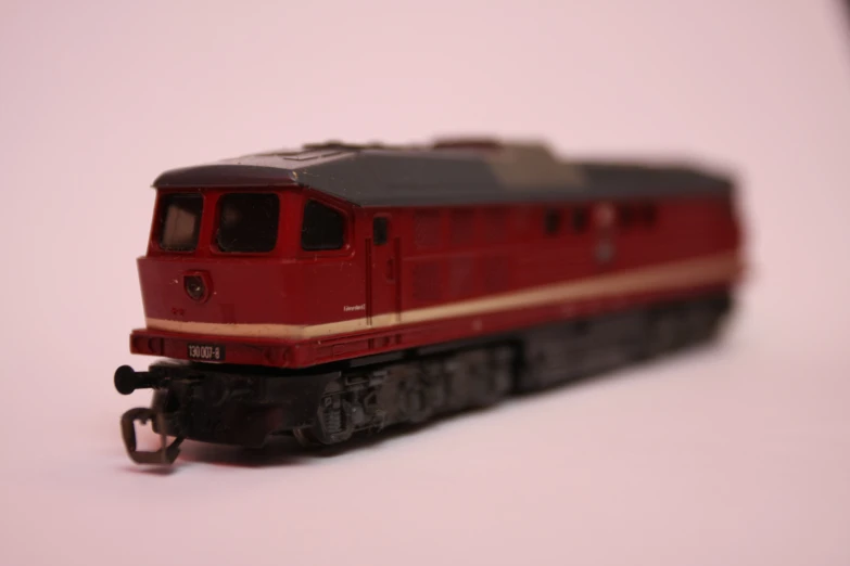 a toy train is shown on a white table