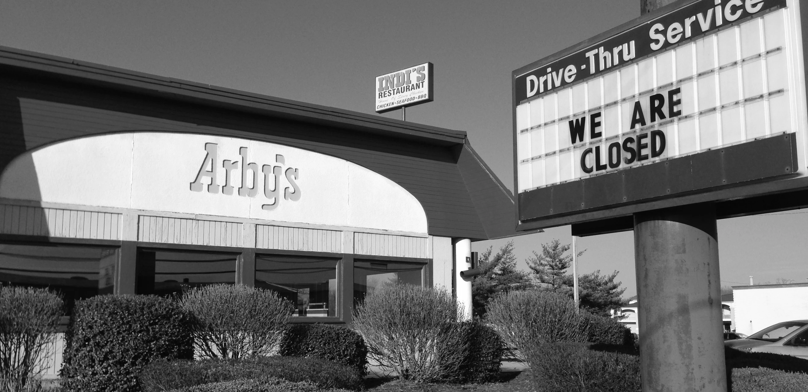 a black and white picture of a drive - thru service building