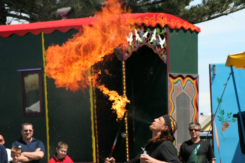 a person on stage with an open flame
