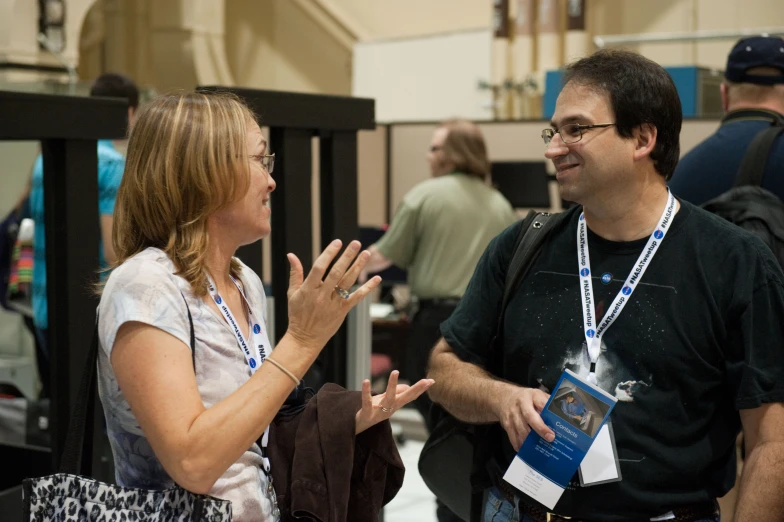 a woman talking with a man in an event