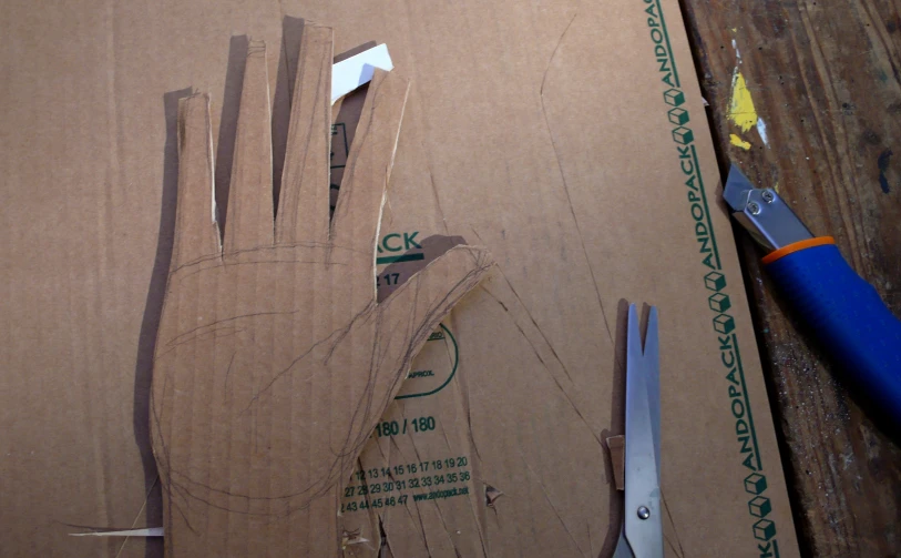 a cardboard board that has an hand cut out of it