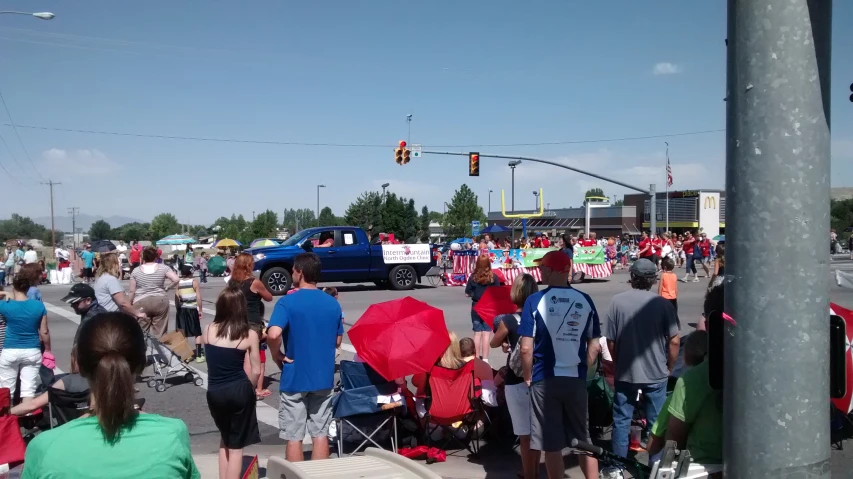 a group of people standing on the sidewalk