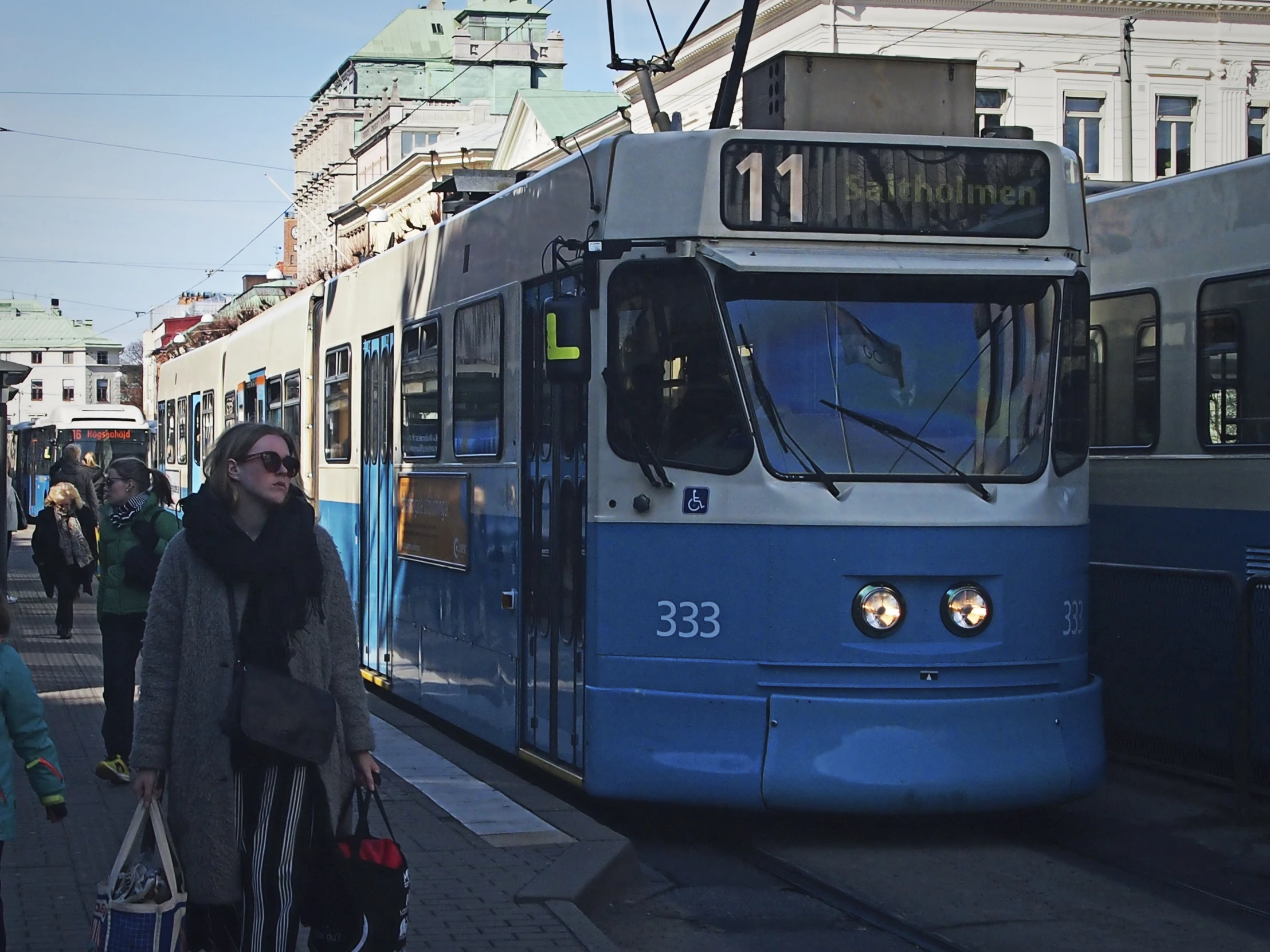 people walking near a tram car and streetcar train