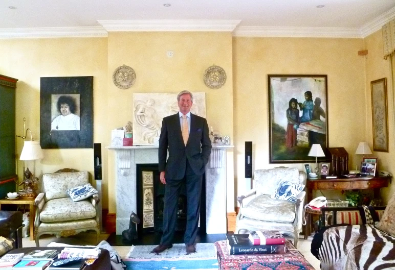 an elderly man wearing a suit in a formal living room