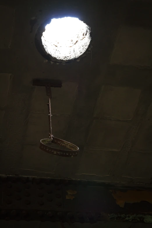 a ceiling with a light shining in the center of it