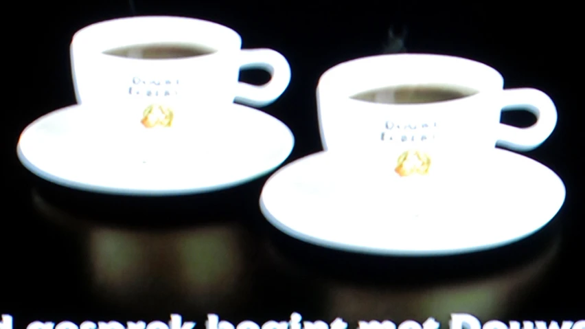 there is a tv screen showing coffee cups