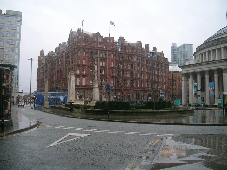 the old, elaborate building is located near a fountain